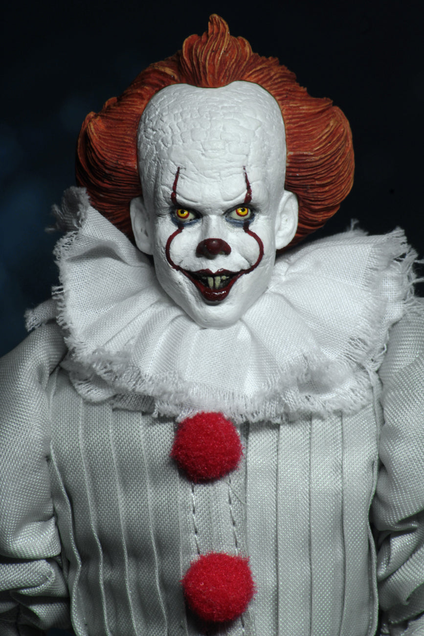 This is an It Movie 2017 Pennywise NECA action figure and he has orange hair, grey suit with red balls, white face, yellow eyes and white fluffy collar.