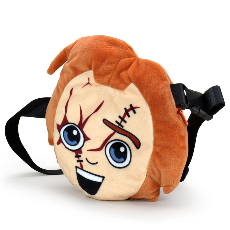 This is a Child's Play Chucky Kidrobot Phunny plush fanny pack bag and he has orange hair, cuts, stitches, a smile and a black strap.