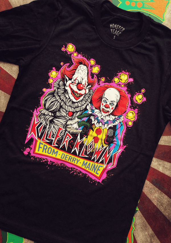 This is an It movie Pennywise t-shirt and he has red hair and nose and mentions Derry and he has a white face and yellow clown suit with red balls.