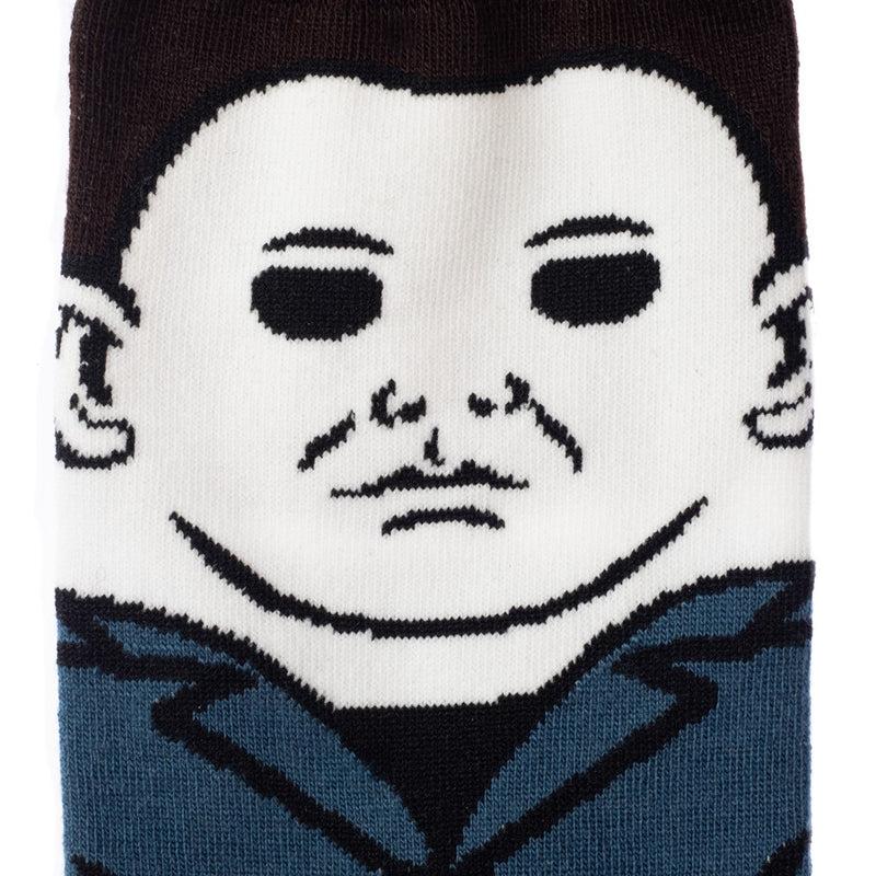This is a close up of a pair of Halloween Michael Myers 360 crew socks and he has on blue coveralls, a white mask and has brown hair.