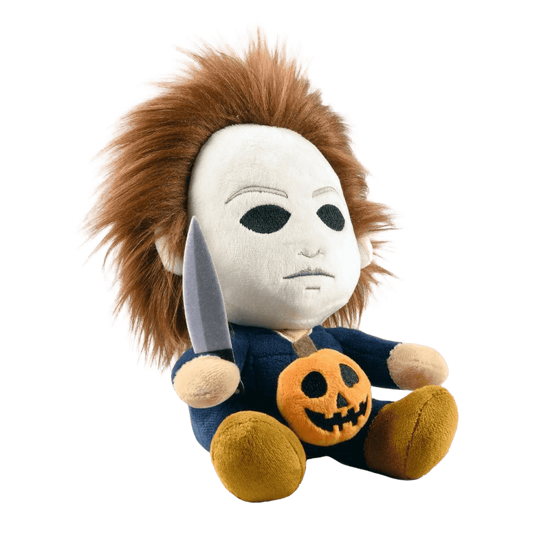 This is the side of a Kidrobot Halloween Michael Myers Phunny stuffed plush that has a white face, brown hair, blue coveralls, a silver knife and orange pumpkin.