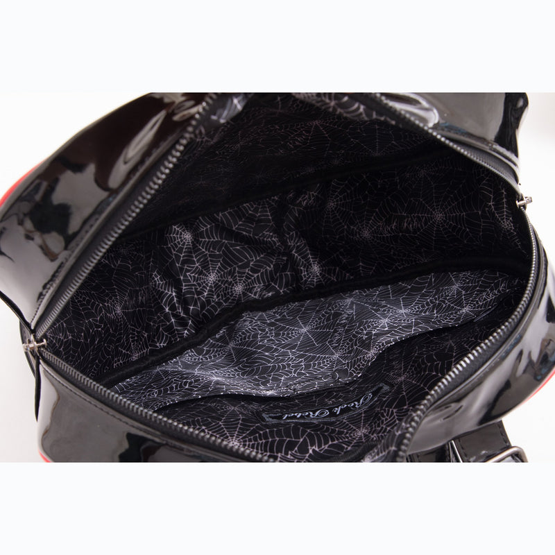 This is a Lily Munster heart shaped backpack purse and it has a cobweb lining on the inside.