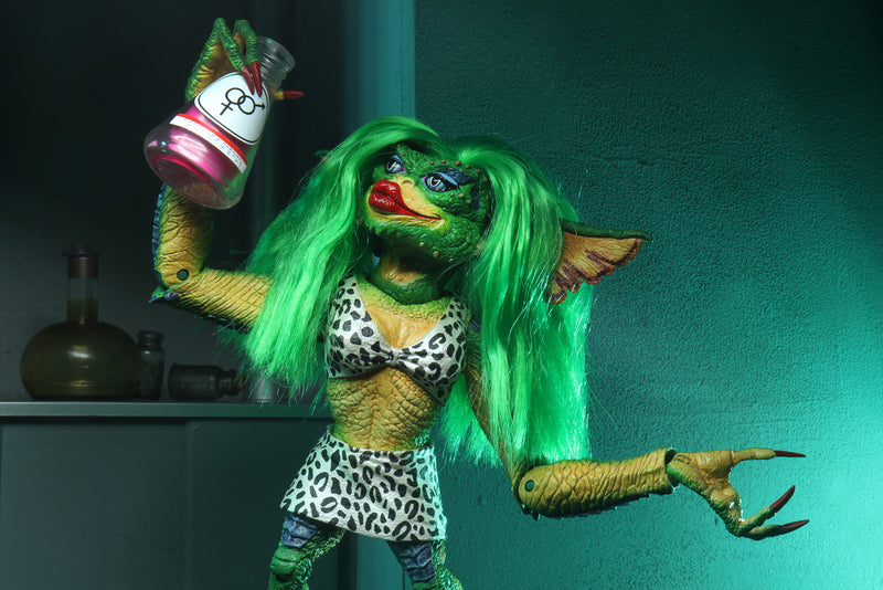 This is a NECA Gremlins 2 Greta 7" Ultimate action figure and she has long green hair and she is drinking a pink potion.