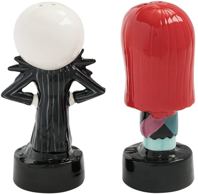These are Nightmare Before Christmas Jack & Sally salt & pepper shakers and he is white & black with his hand on his hips and she has red hair and a patch dress.