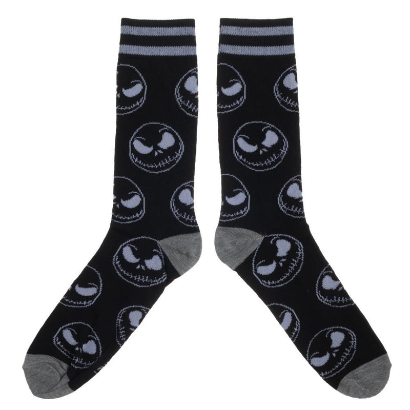 This is a pair of Nightmare Before Christmas Jack Skellington crew socks that are black with grey skull faces and two stripes at the top.