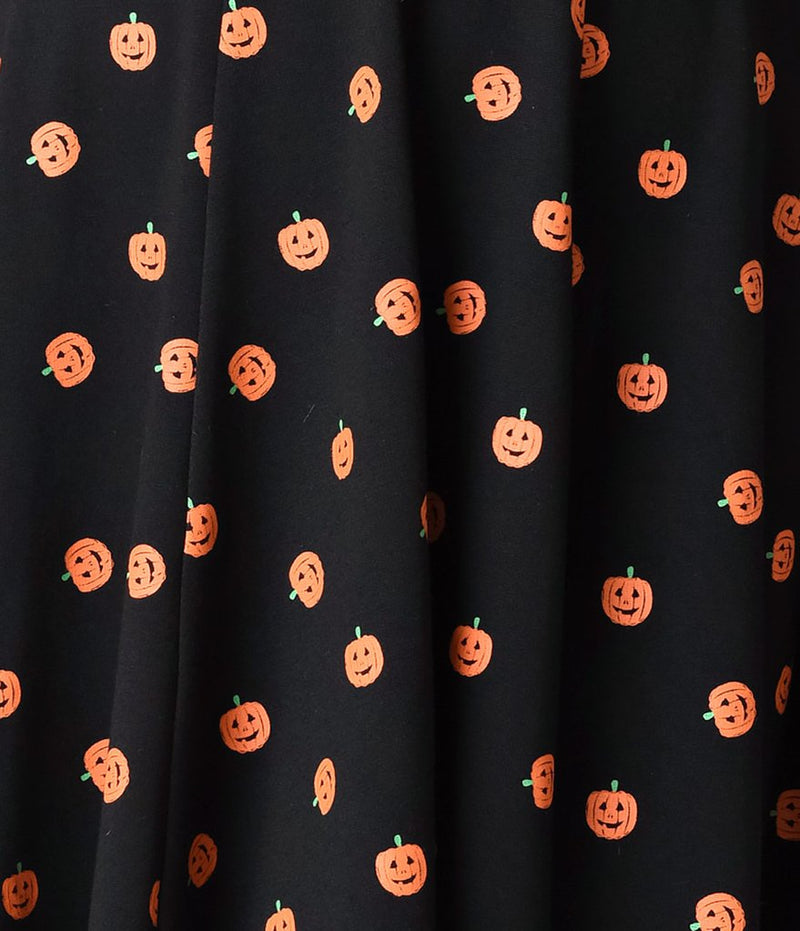 This is a black pinup flare dress with orange pumpkin print.