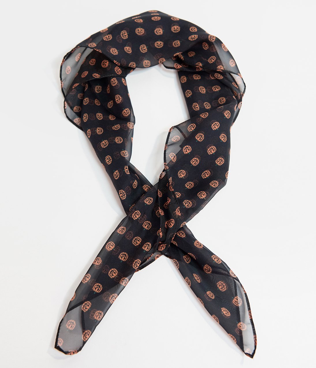 This is a black pinup style chiffon hair scarf that has orange pumpkins on it.