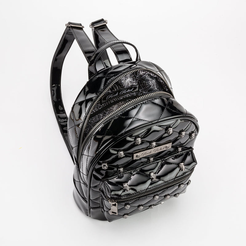 This is a vegan black Universal Monsters purse backpack that is shiny and has cobweb lining on the inside.