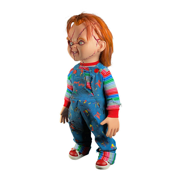 This is a Seed of Chucky life sized doll and he has blue coveralls, striped shirt, orange hair, scars on his face and red shoes. 