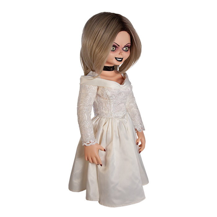 This is a Seed of Chucky Tiffany life size doll and she is wearing a white wedding dress and black choker and she has red painted nails..