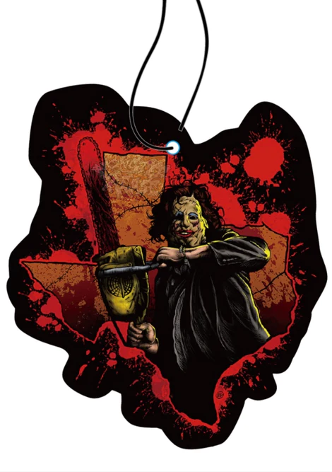 This is a Texas Chainsaw Massacre Leatherface air freshener and he has a skin mask and is holding a chainsaw and it is the shape of Texas with blood splatter.
