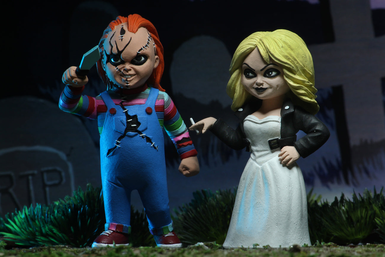 Chucky NECA action figure is holding a knife and standing next to Tiffany, who is holding a cigarette.
