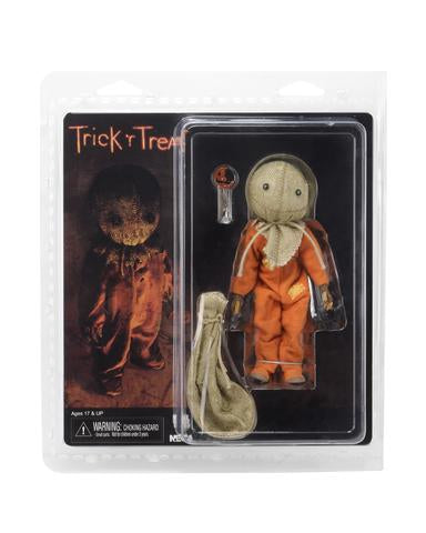 This is a Trick 'R Treat Sam NECA 8" clothed action figure and he is wearing an orange pajamas and has a burlap mask, bitten lollipop and burlap bag.