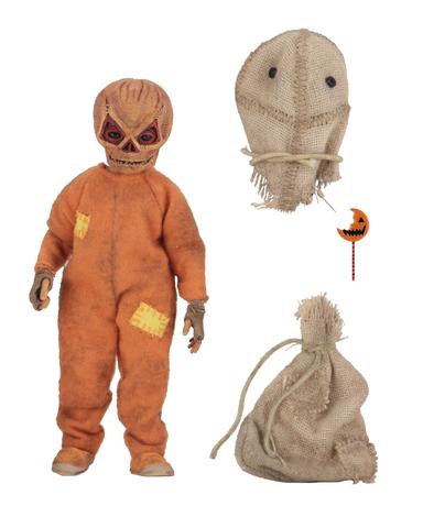 This is a Trick 'R Treat Sam NECA 8" clothed action figure and he is wearing an orange costume and has a burlap mask and burlap bag.