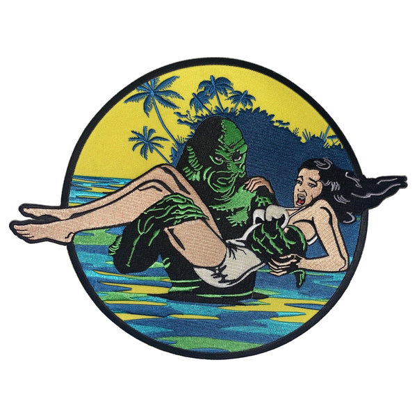 This is a Universal Monsters Creature From the Black Lagoon patch and has a woman with dark hair and a white bathing suit being carried out of the water by a green creature.