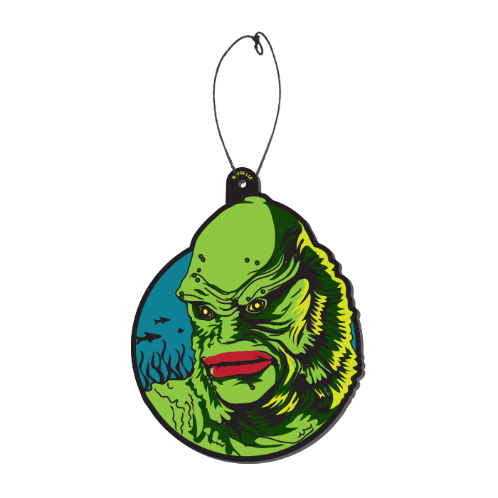 This is a Universal Monsters Creature From the Black Lagoon air freshener by Trick Or Treat and he has green skin and gills and scales with red lips and is in front of a blue circle and fish, with a plastic hanger.