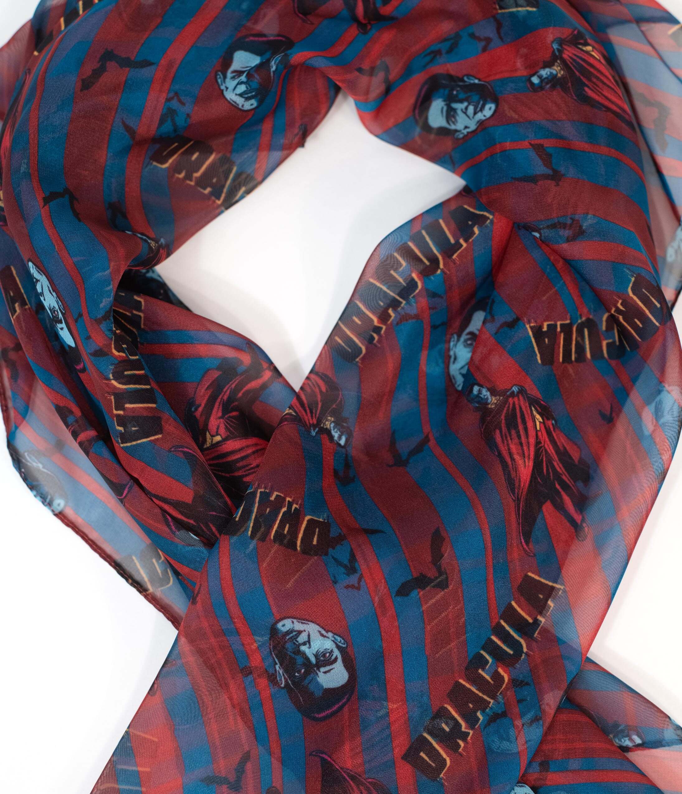 This is a Universal Monsters Dracula chiffon hair scarf by Unique Vintage and it is red and blue with his head and cape.
