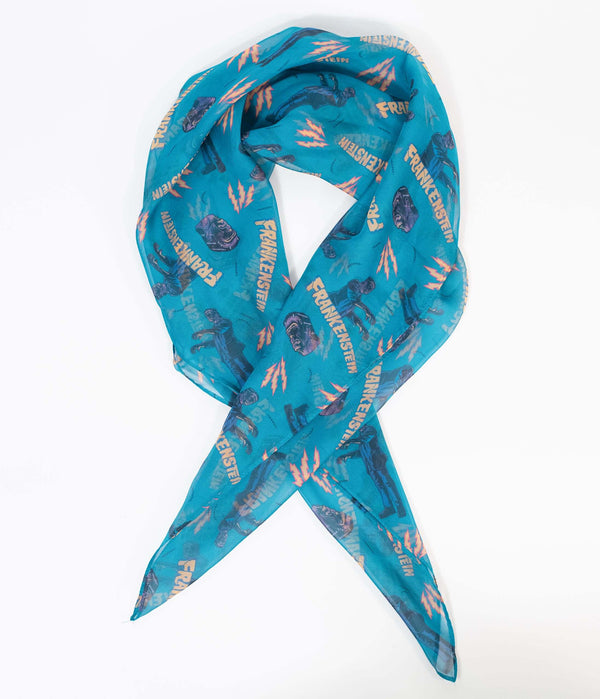 This is a Universal Monsters Frankenstein chiffon hair scarf that is teal and has  yellow lightening bolts on it.