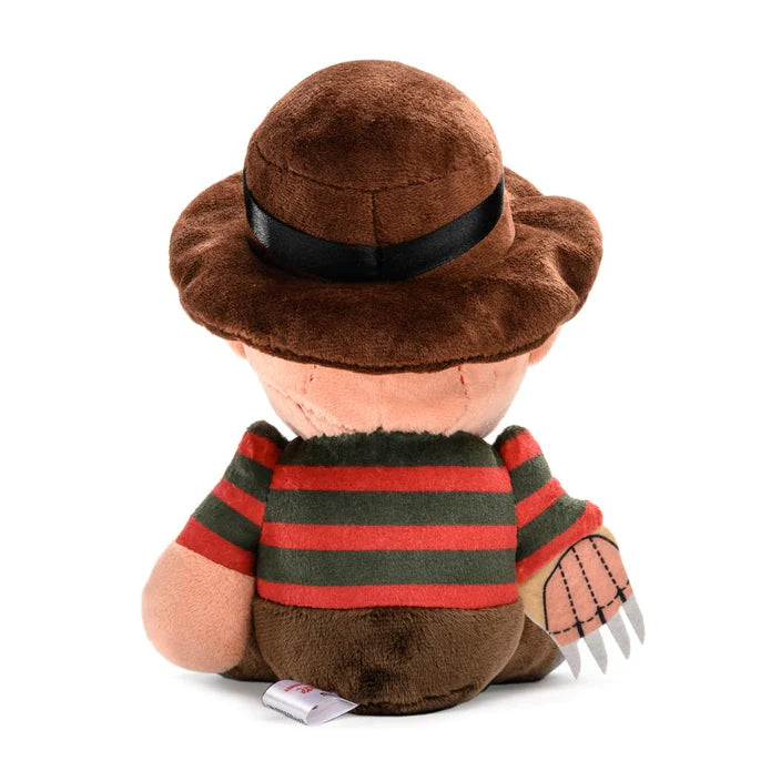 This is a Nightmare On Elm Street Freddy Krueger plush and he has a brown hat, red and green striped sweater, brown pants and knives on his hand.