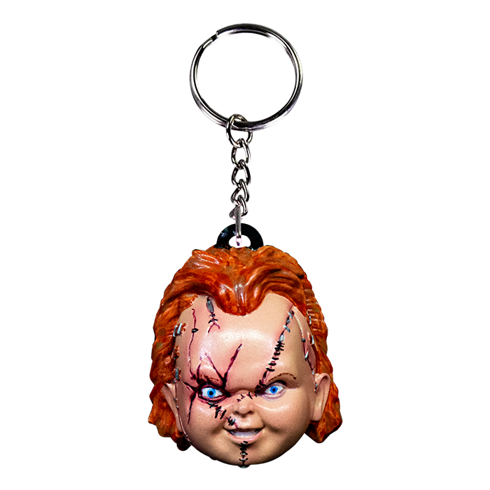 This is a Seed of Chucky Chucky keychain and he has a scarred face, orange hair, blue eyes and a silver chain and loop.