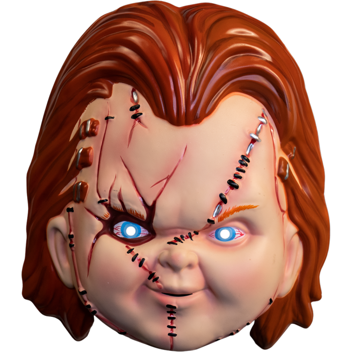 This is a Seed of Chucky vacuform mask and he has orange hair, blue bloodshot eyes, and his face has scars, cuts, staples and stitches.